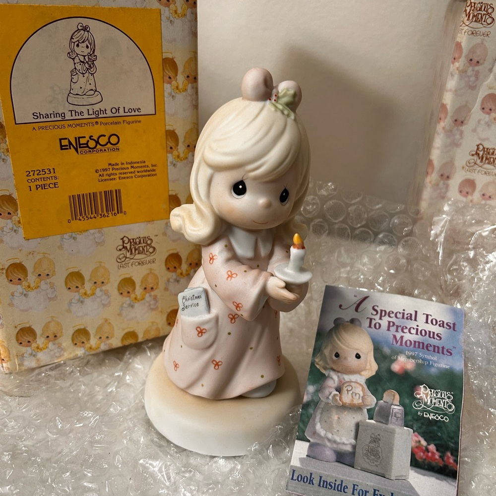 Precious moments figurine.   Sharing The Light of Love